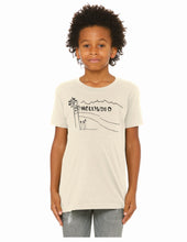 Load image into Gallery viewer, A child model wearing a cream-colored t-shirt with a black line art graphic of the Hollywood sign and palm trees, paired with gray jeans, against a plain white background.